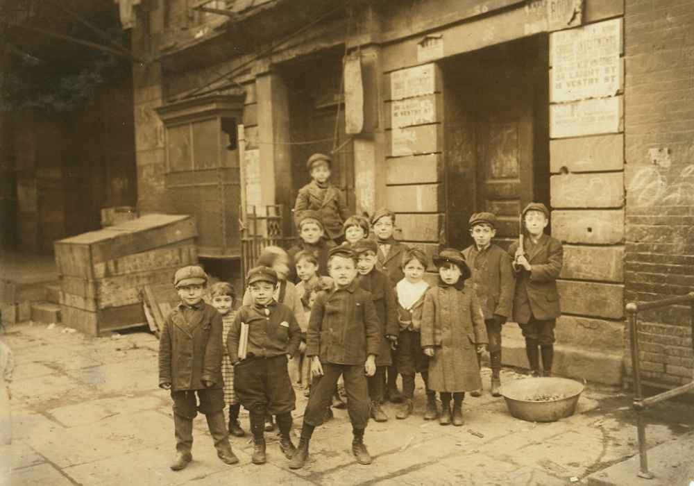 Group of children standing near the entrance of a theater in 1910 in Troy, New York.